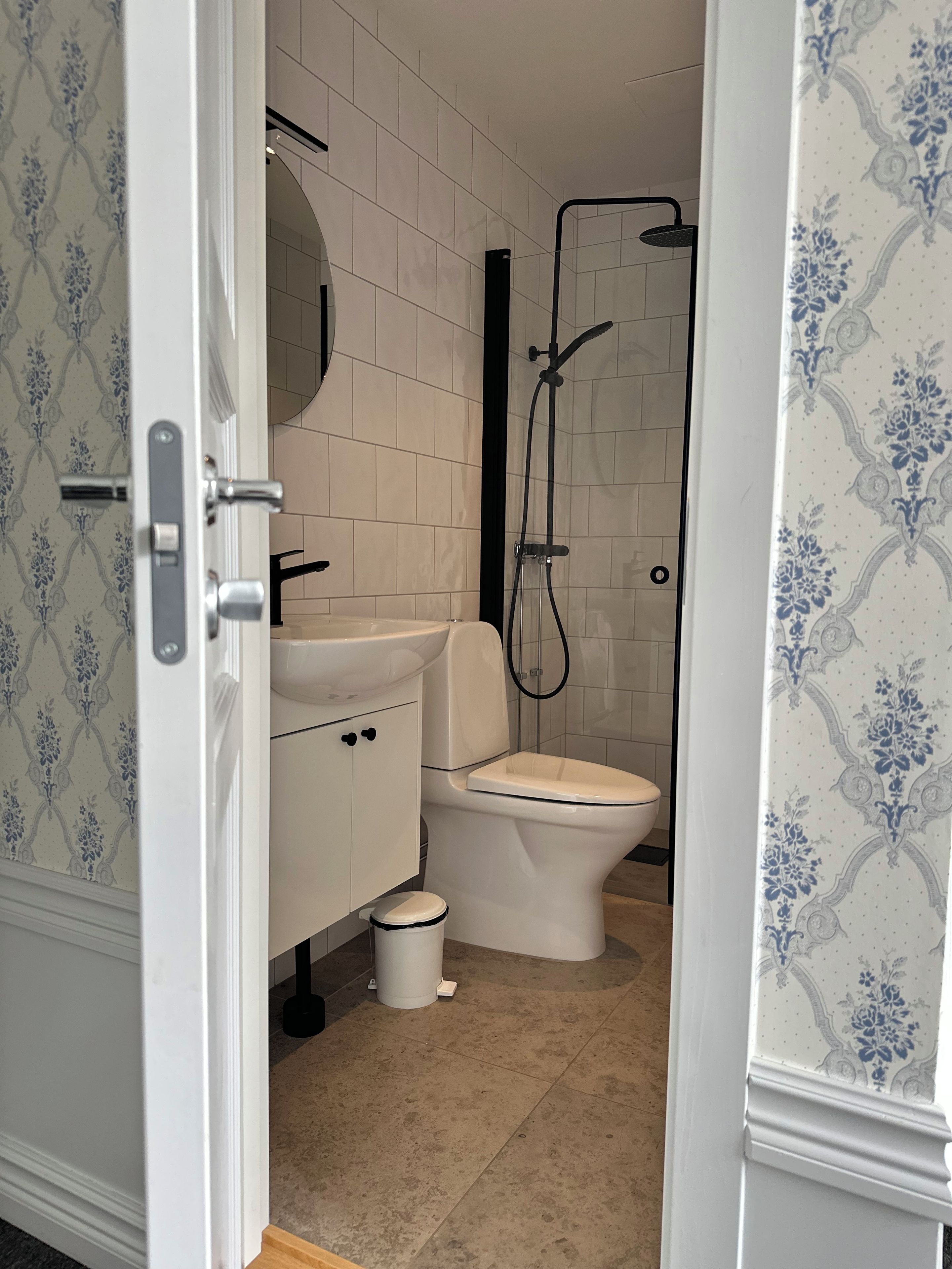 Un baño con inodoro, lavamanos y ducha.