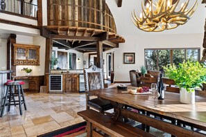 A spacious kitchen with a built-in refrigerator, wooden cabinets, and a dining area with a large wooden table and chairs. - Spacious 6700 SQFT Home | 4 Ensuite Bedrms + Kids Bunkrm + Game Rm + Media Room (Powell Butte)