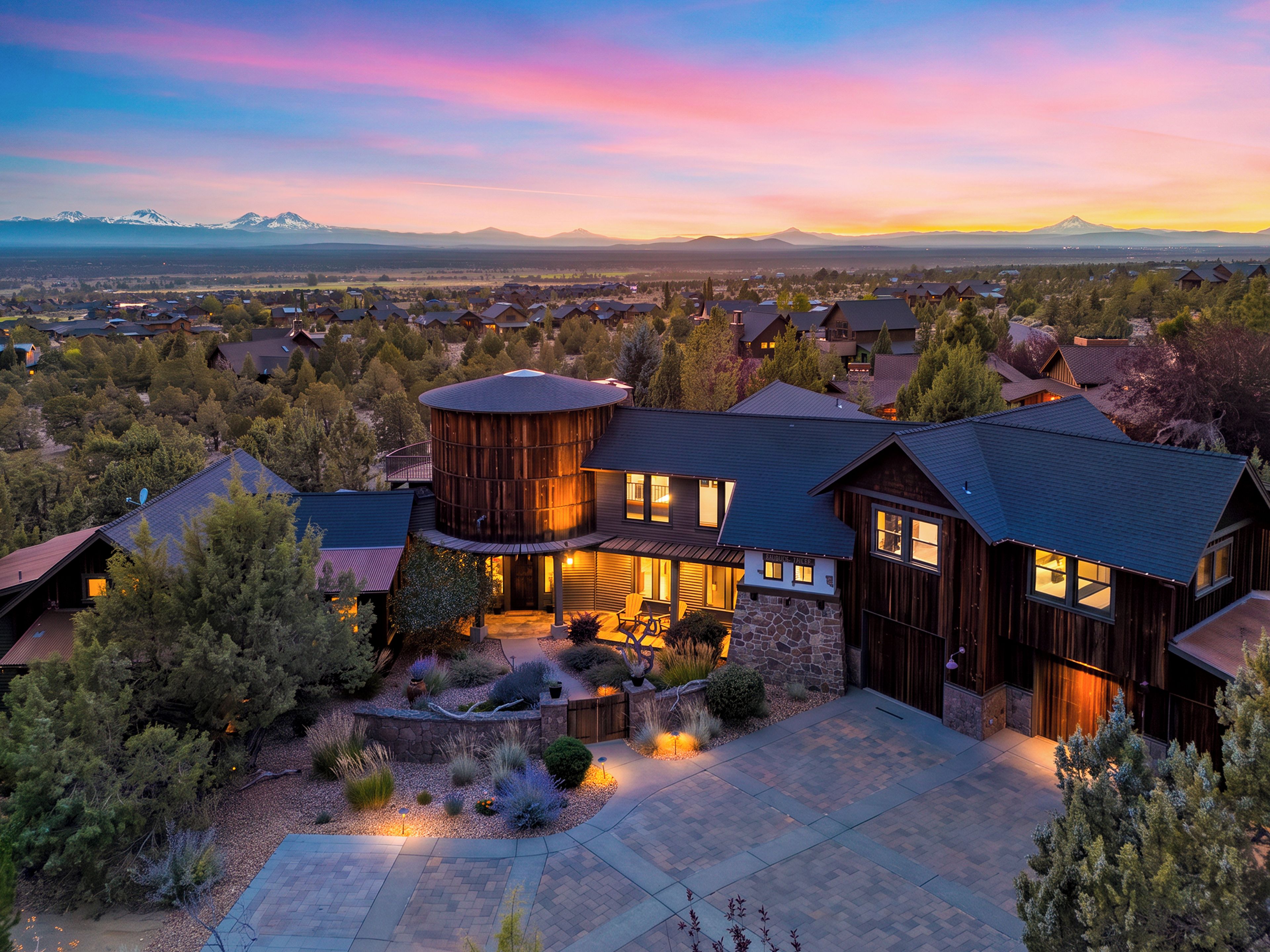 A large, modern house with a stone foundation, multiple bedrooms, and a spacious outdoor area with a patio.