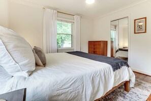 A bedroom with a bed, a wooden dresser, a mirror, and a window with curtains. - 9 Mi to Dtwn Nashville! Updated Home + Large Yard (Nashville)