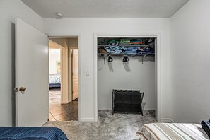 A bedroom with a closet containing hanging storage and a small shelf. - Yard & Patio! Naples Home By Botanical Garden (Naples)
