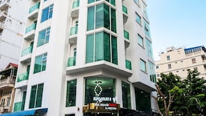 A multi-story hotel with a modern design, featuring a prominent entrance with a sign that reads 'The Movie Hotel by MECON.' - The Movie Hotel by Mecon (Phnom Penh)