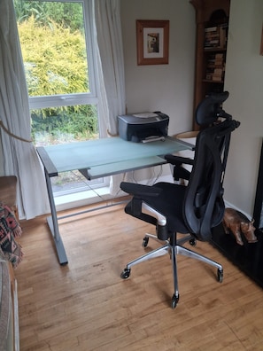 A home office with a desk, chair, printer, and a window with curtains. - WatersEdge, offers beachfront accommodation a short distance from Mulranny, (Mallaranny)