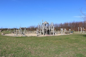 A playground with climbing structures and a small shelter. - Holiday home Baltic Sea love (Glowe)