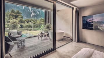 A modern interior with a large sliding glass door leading to an outdoor patio area.