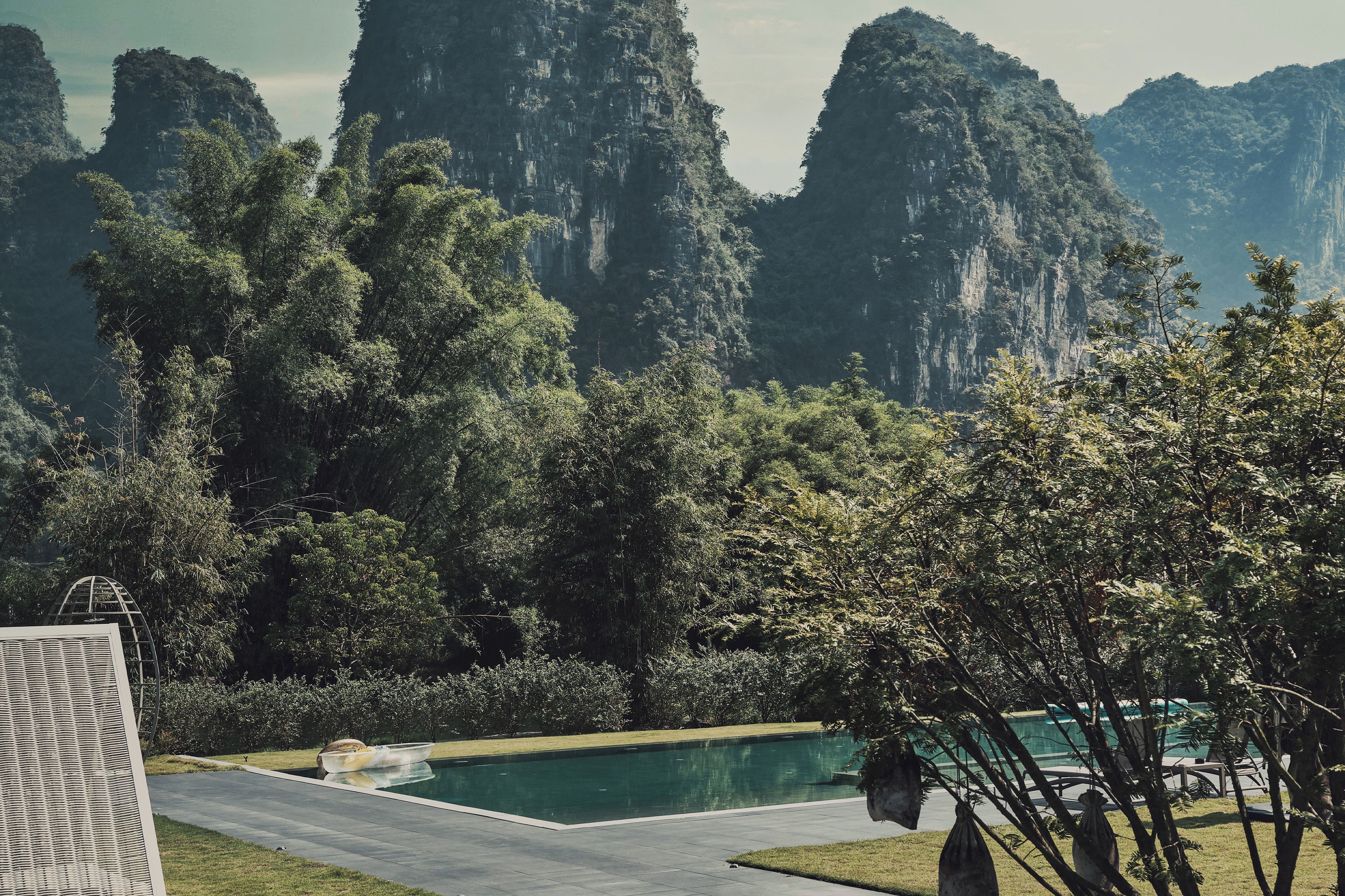 A swimming pool with a view of a mountainous landscape.