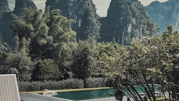 A swimming pool with a view of a mountainous landscape.