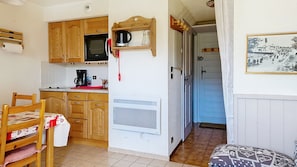 A compact kitchen with wooden cabinets, a microwave, and a coffee maker. - AGA2 VIEW & MOUNTAIN Alpine Chalet (3 People) (Châtel)