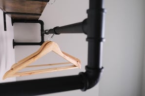 A wooden hanger on a black metal rack. - The Marlowe (Southport)