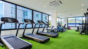 A gym with treadmills, weight machines, and a green artificial turf floor. - Quiet Sea-view Studio, Walk to Nai Harn Beach (Rawai)