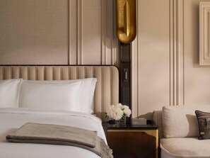 A hotel room with a bed, a nightstand, a lamp, and a chair. - The Langham, Custom House, Bangkok (Bangkok)