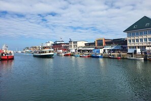 A harbor with boats docked and buildings along the waterfront. - to the view of the sun (Kröpelin, OT Wichmannsdorf)