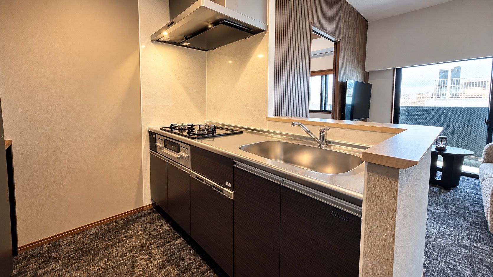 A compact kitchen with a gas stove, a sink, and a dishwasher.