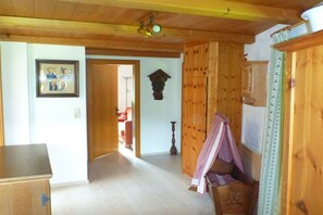 A wooden interior with a bed, a dresser, and a framed photo on the wall. - Holiday home in Auffach with swimming pool (Auffach)