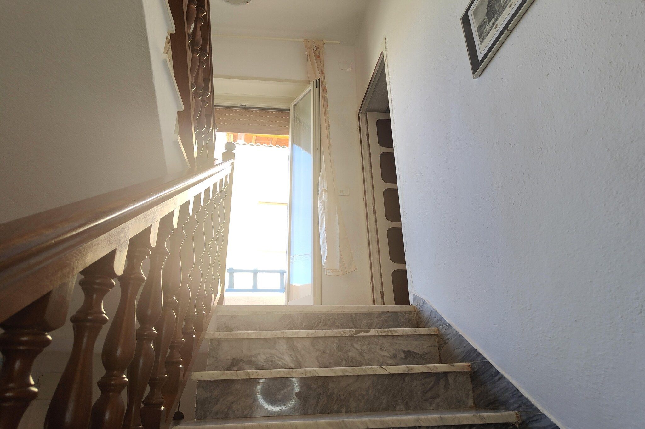 A staircase with wooden balusters leading to a landing.