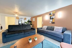 A modern living room with two sofas, a coffee table, and decorative wall art. - Opera apartment in the heart of Paris (Paris)