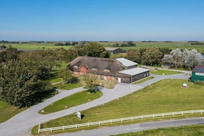 A rural property with a large house, a barn, and a fenced area. - Holiday apartment 5 "Gröde" (ID 474) (Tating)