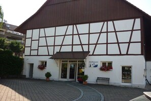 A traditional half-timbered building with a sign indicating it is a hotel. - Bernhard Winery Type A (Daisendorf)