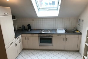 A compact kitchen with a skylight, a built-in oven, and a sink. - ||---------------------------------at the hop garden---------------------|| (Lindau)