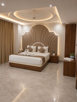 A modern bedroom with a large bed, a headboard with built-in lighting, a bedside table with a phone, and a nightstand with a lamp. - Royal Damyanti Palace (damoh)
