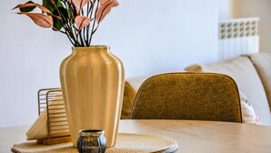 A dining table with a vase and a small container, a woven placemat, and a chair. - Casa Sassolino - Torre Cajetani (Torre Cajetani)