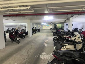 A multi-level parking garage with several rows of parked motorcycles. - Utopia D Private & Quiet · 1BR · Pets OK · 500mbps (Rawai)