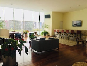A spacious living area with a sofa, chairs, a dining table, and potted plants. - Large Apartment, Hosts 2 -4 Adults/ Children.1-bedroom, 1 double Sofa bed. (Mexico)