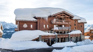 A multi-story wooden building with a sign for 'SPA SOUVERAUX' and a 'CGH' logo. - Cgh Residences & Spas Le Lodge Hemera (Montvalezan)