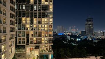A multi-story building with a modern design, featuring balconies and a central courtyard.