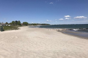 A sandy beach with a clear sky and calm sea. - Holiday home with 4 bedrooms (Scharbeutz)