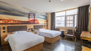 Een hotelkamer met twee bedden, een bureau, een stoel, een klein tafeltje en een groot raam met gordijnen.