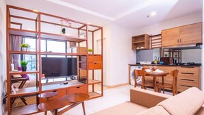 A modern apartment with a living area, kitchenette, and a dining space. - Timurbay Seafront Apartment by My Seasons (Kuantan)