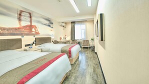 Une chambre d’hôtel avec deux lits, un bureau, une chaise, une petite table, un téléviseur et une fresque représentant un pont.