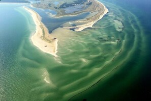 An aerial view of a coastal area with a sandy beach and clear waters. - Electricity View No. 7 (Seeheilbad Zingst)