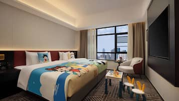 A hotel room with a large bed, a TV, a desk with a chair, and a view of a cityscape.