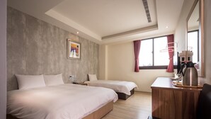A hotel room with two beds, a wooden desk, a coffee maker, and a window with curtains. - Yadi Hotel (Puli)