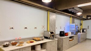 A food service area with multiple counters, each with a variety of dishes and a digital ordering system. - Yadi Hotel (Puli)
