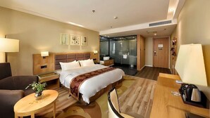 A hotel room with a bed, bedside tables, a desk, a chair, a lamp, a plant, and a shower area. - Homeinn Superior Hotel (Hefei)