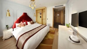 A hotel room with a large bed, a desk with a flat-screen TV, a wardrobe, and a mirror. - Homeinn Superior Hotel (Hefei)