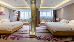 A hotel room with two beds, a large vase with branches, and a purple floral carpet. - Lavande Hotels (Weihai)