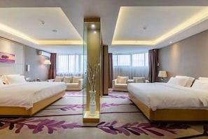 A hotel room with two beds, a large vase with branches, and a purple floral carpet. - Lavande Hotels (Weihai)