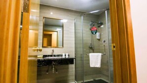A modern bathroom with a glass shower enclosure, a sink with a marble countertop, and a mirror above the sink. - Greentree INN Huaibei Xiangshan District Guogou Square Hotel (Huaibei)