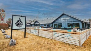 A building with a sign reading 'GOODFIRE' and a logo on a signpost. - Casco Bay Inn (Freeport)