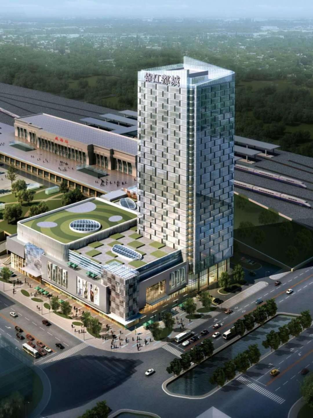 A modern building with a prominent tower, a flat-roofed structure with a circular green area, and a parking lot.