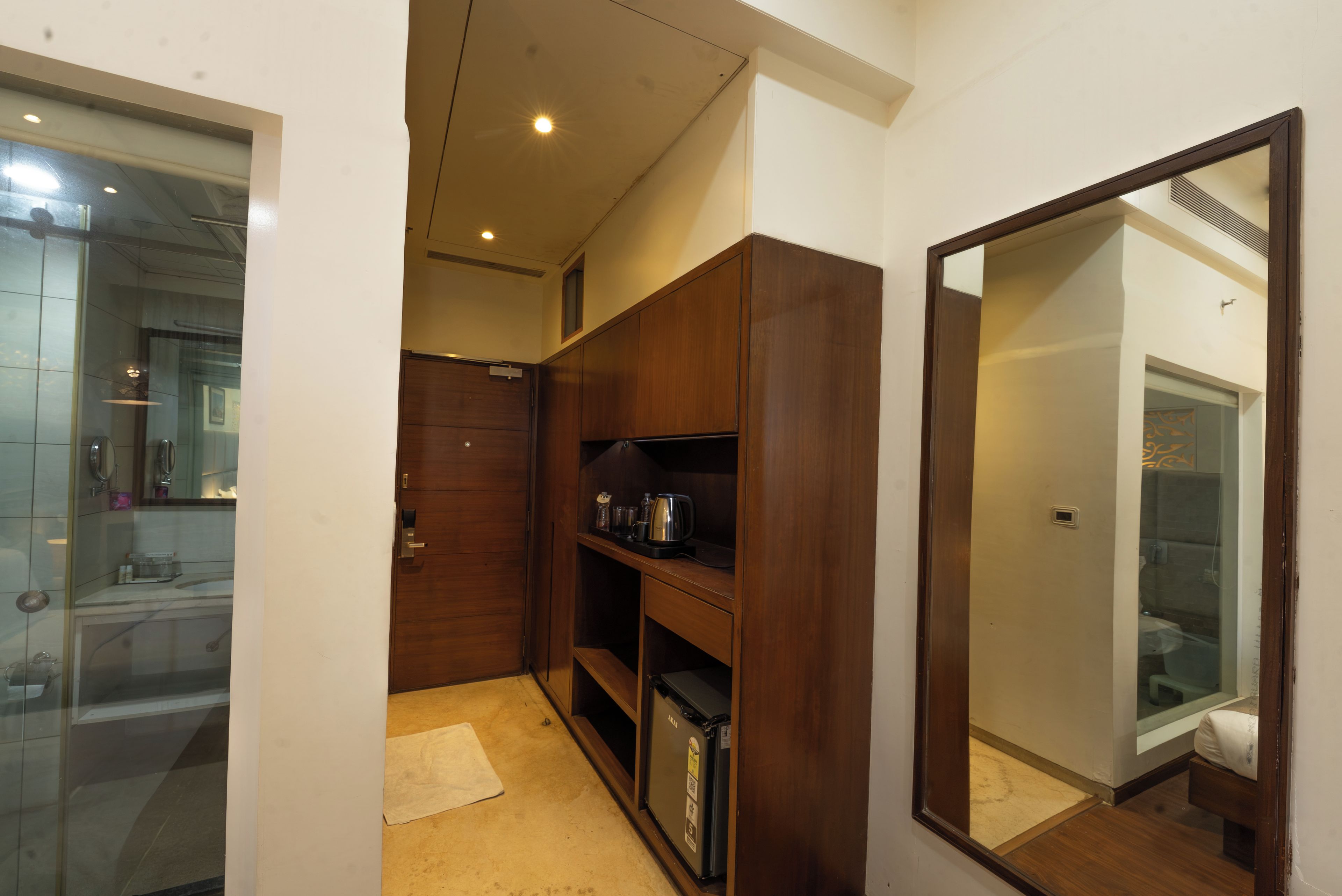 A compact bathroom with a mirror, a sink, and a shower area.