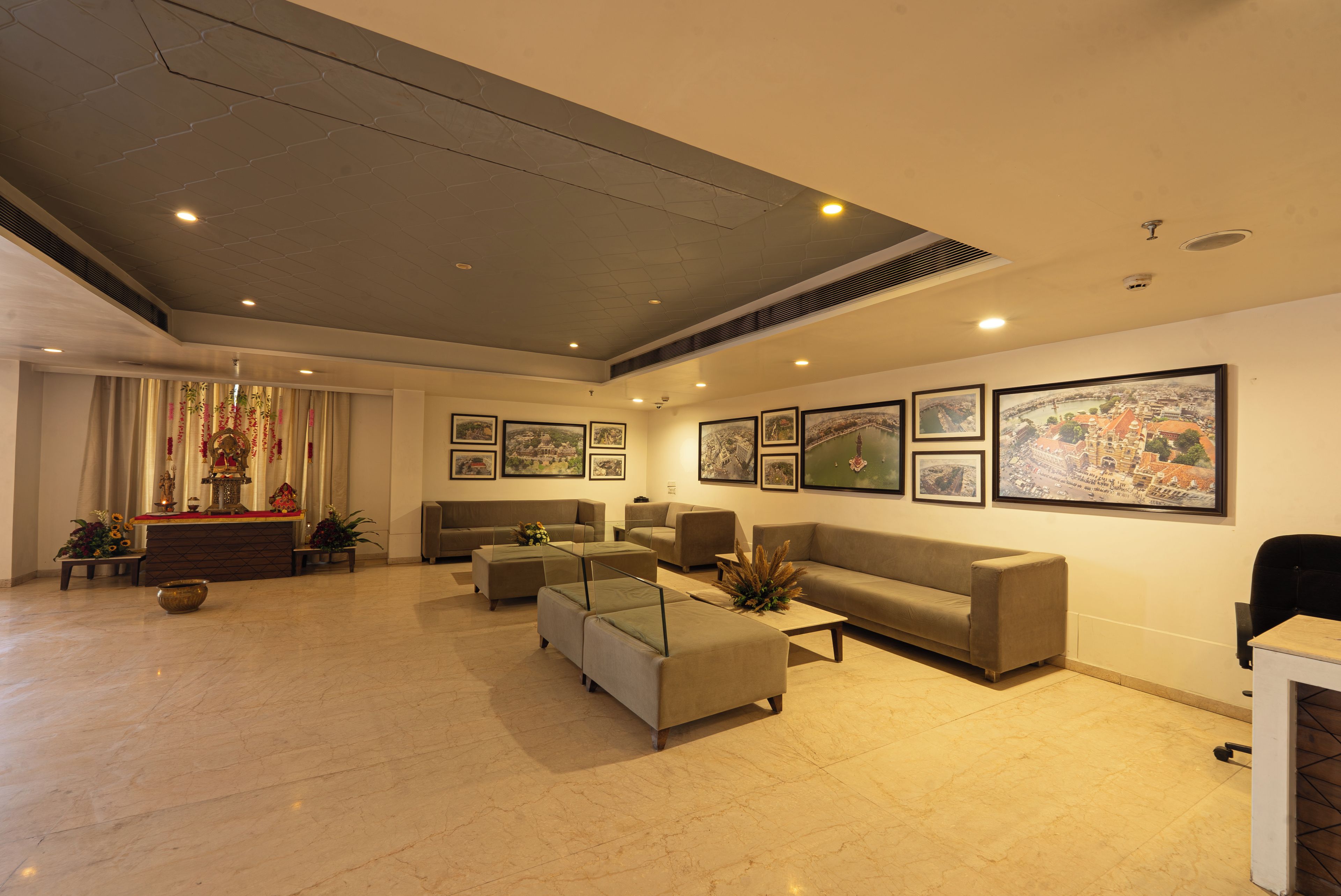 A spacious lobby with a high ceiling, multiple seating areas, and a reception desk.