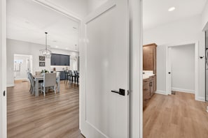 A modern kitchen with dark cabinets, a wooden countertop, and a hanging light fixture. - Fairway Vista - 3/3 w/ 4-Seat Golf Cart in The Villages - Moultrie Creek (Moultrie Creek, The Villages)