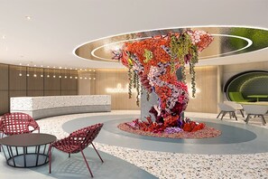 A reception area with a central decorative column, seating arrangements, and a modern interior design. - lyf Cebu City (Cebu City)