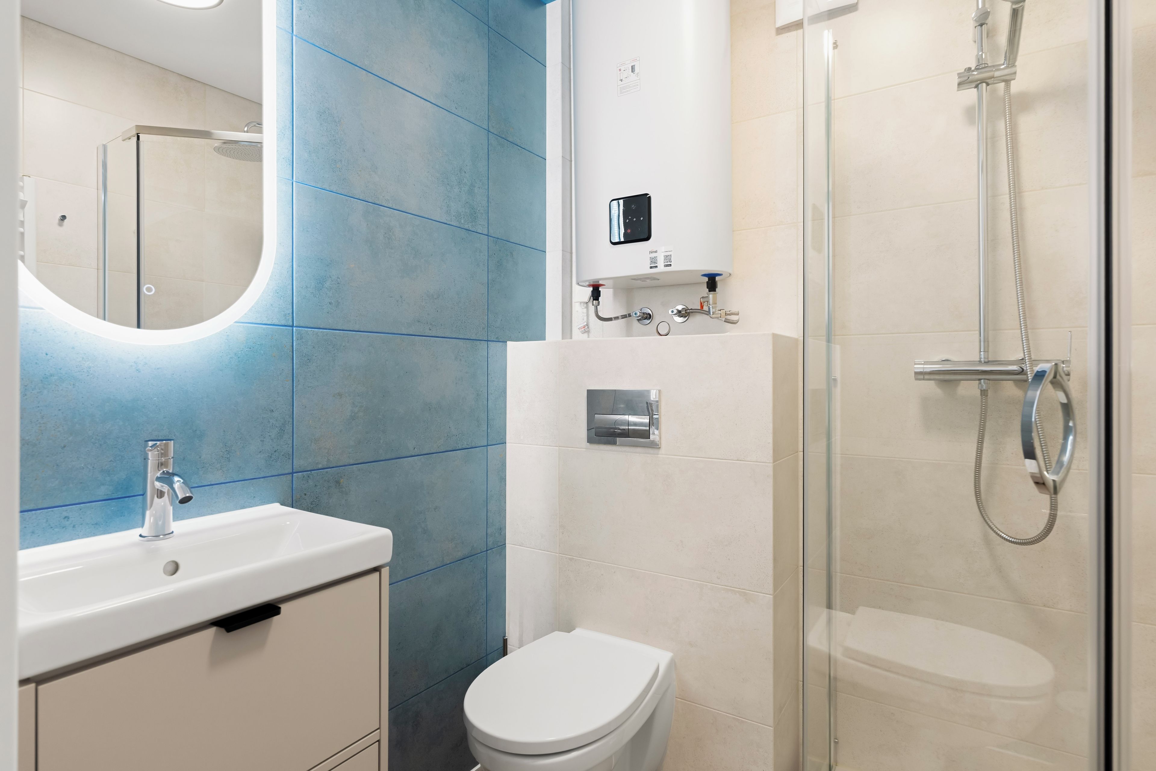A modern bathroom with a white sink, a toilet, and a glass-enclosed shower.