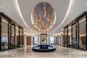 A spacious lobby with a central fountain, high ceilings, and modern decor. - Argyle Grand Hotel Nanping (Nanping)